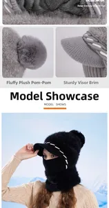 Detail of winter knitted hat with faux fur lining and plush pom-pom for outdoor warmth