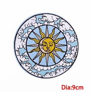 Close-up of a 9cm embroidered sun and moon patch with detailed celestial facial features
