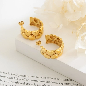 Creative 18K gold plated heart link C-shaped hoop earrings on a clean white pedestal