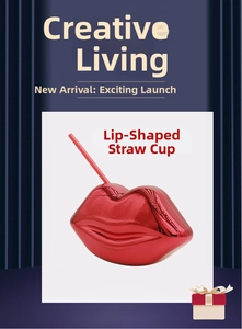 Macro detail of red lip-shaped disco ball cup with metallic finish and matching straw