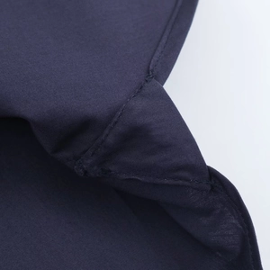 Detailed close-up showing the dark blue poplin fabric texture and reinforced double stitching