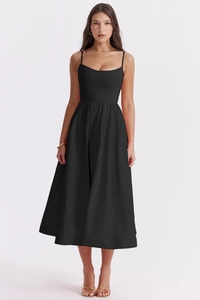 Detail of slim fit black midi dress featuring elegant backless design and thin straps