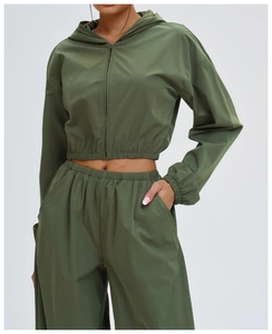 Detail of army green outdoor windproof jacket with elastic cuffs and woven fabric texture
