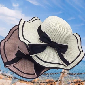 Summer beach straw hats with large wavy brims and elegant black bows in two colors