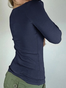 Detail of dark blue Y2K long sleeve t-shirt featuring a button neck and slim fit texture