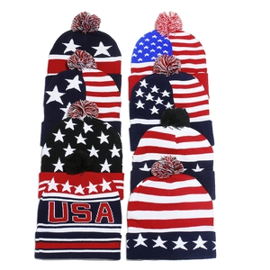 Knit American flag beanies with USA lettering and pom-poms for winter warmth