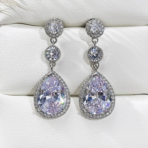Detailed view of silver pear-shaped drop earrings with AAA zirconia inlay and shiny stones