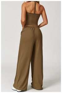 Rear view of olive green backless halter top and wide-leg drawstring pants outfit