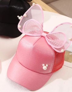 Detail of pink mesh baseball cap featuring a pearl Mickey Mouse motif and large tulle bow