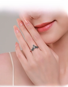 Macro view of S925 sterling silver ring with black diamonds worn on model's finger