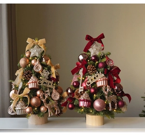 Detail of mini Christmas trees with LED lights in champagne gold and vintage red themes
