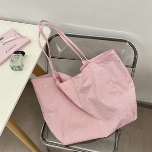 Detailed interior of a pink canvas star tote showing red striped lining and spacious room