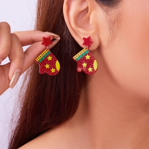 Detail shot of Christmas glove earrings with red glitter finish and yellow star on a model