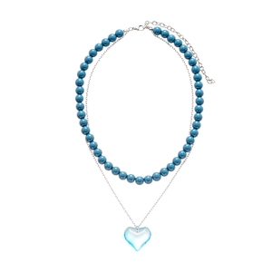 Double-layer necklace with blue resin beads and a translucent heart pendant on a silver chain