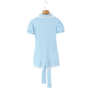 Detailed back view of light blue polka dot romper with delicate white lace trimming