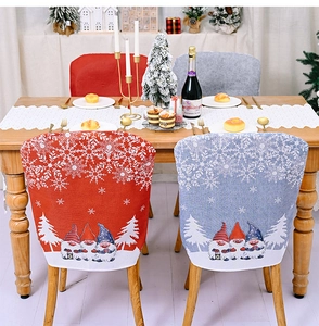 Detail of Christmas chair covers with gnome and snowflake patterns on high-elastic fabric