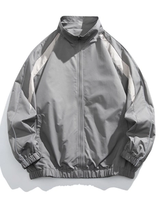 Close-up of men's gray stand collar jacket with contrast white panels and elastic cuffs