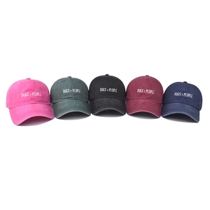 Washed cotton baseball caps in five colors with white DOGS > PEOPLE embroidery detail
