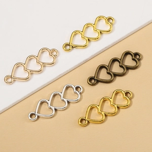 Five assorted hollow heart connectors for DIY jewelry making in multiple metal finishes
