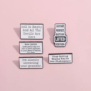 Set of five minimalist white enamel pins with literary quotes and black letter engravings