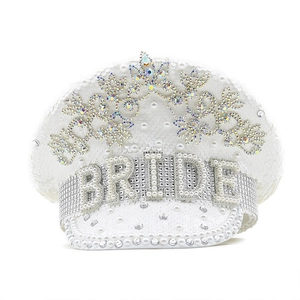 Macro shot of white bridal captain hat featuring pearls and BRIDE rhinestone lettering