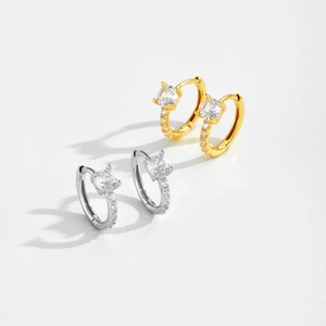 Macro view of gold and silver S925 sterling silver hoop earrings with clear round crystals