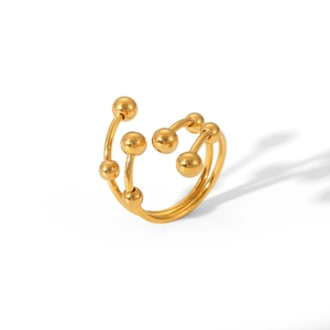 Detailed close-up of golden multilayered bead open ring in polished stainless steel finish