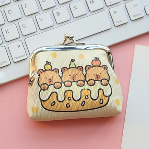 Detailed view of beige Kapibara coin purse with vintage clasp on a pink office desk