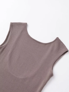 Detailed macro view of the cocoa brown knit fabric texture and round neckline of the top