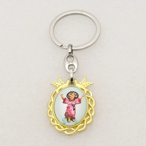 Detailed close-up of religious saint icon pendant with gold braided frame on silver ring