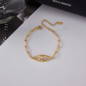 Detailed close-up of 18K gold stainless steel paperclip chain bracelet with evil eye charm