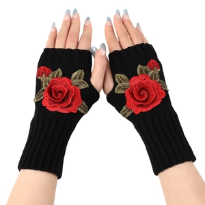 Women's black knit fingerless gloves with red rose embroidery in a top-down view