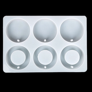 Macro detail of 6-cavity silicone mold with round and ring shapes for resin crafting