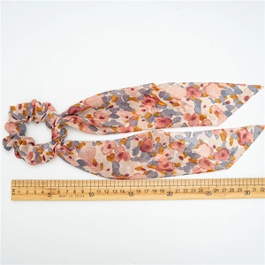 Floral print scrunchie with long ribbons showing a total length of 31cm against a ruler