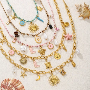 Detail showing a mix of colorful Bohemian jewelry with sea turtle and sun charms