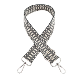 Close-up of geometric woven replacement strap with silver metal lobster clasps