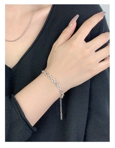 Close-up of S925 sterling silver pig nose link bracelet worn on a female wrist