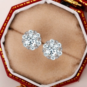 Detail shot of a classic crown flower zircon stud earring in a red velvet jewelry box