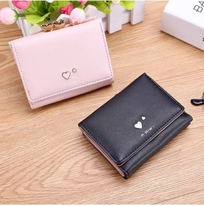 Close-up of pink and black PU leather wallets with heart charm and I miss u text detail