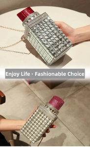 Detail of creative lipstick-shaped evening bag with sparkling rhinestones and gold chain