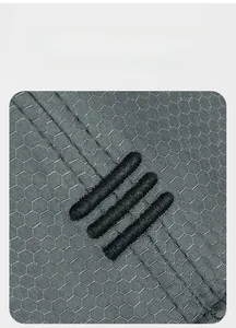 Detailed close-up of breathable honeycomb fabric and embroidery on gray sports cap