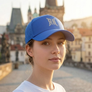 Women wearing blue letter logo baseball cap on city street at sunset for sun protection