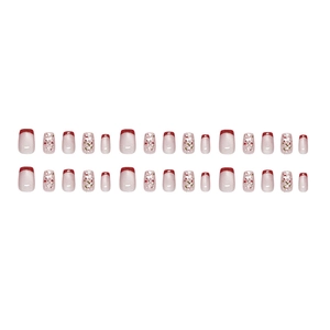 Red French tip press-on nails with glitter floral accents and cat eye shimmer finish
