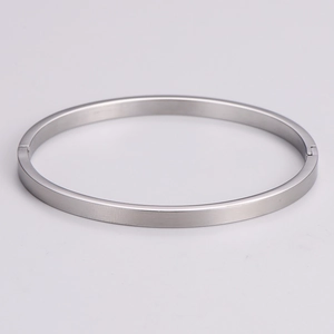 Detail view of silver minimalist bangle with brushed metal finish and hinge closure