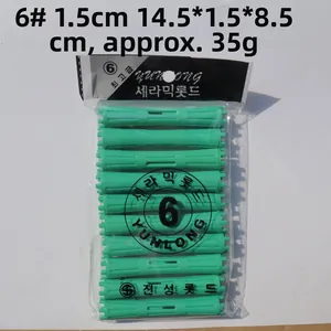 Detail of 10-piece green 1.5cm plastic hair rollers with anti-slip texture and PVC packaging