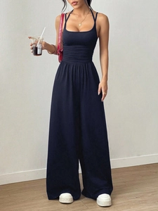Detail of a black sleeveless wide-leg jumpsuit featuring a cinched waist and relaxed fit