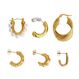 U-shaped gold pearl earrings and layered geometric titanium steel hoops in a set