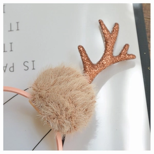 Detail of glittery reindeer antler and soft faux fur pom-pom on Christmas headband