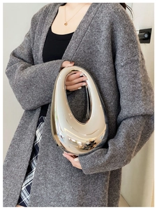Close-up of silver mirror acrylic teardrop clutch bag with reflective metallic finish