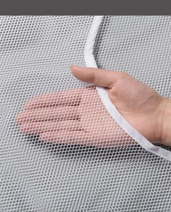 Macro shot of breathable white mesh fabric detail showing polyester texture and holes